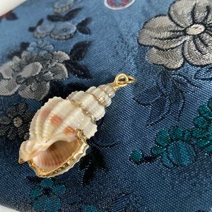 Pendant real seashell outlined with gold and with gold rings for attachment